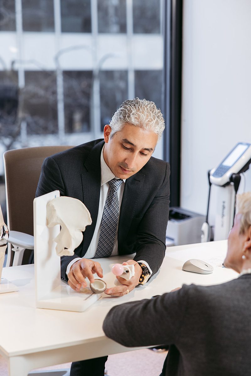 Dr. Mina examining patient knee for meniscus tear in Montreal clinic