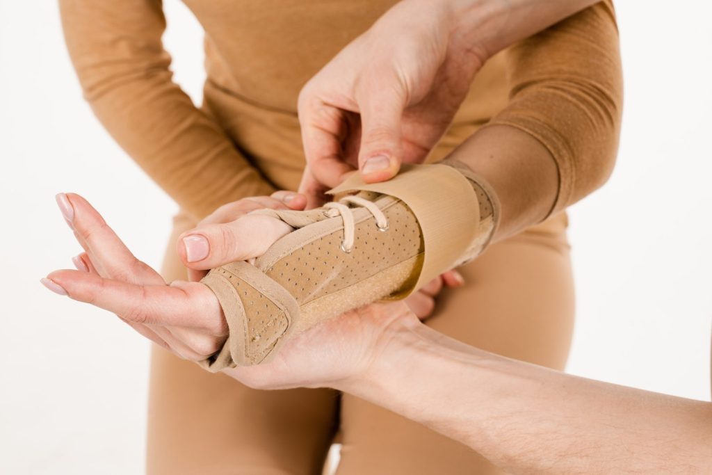 Wrist and thumb splint being fitted, a non-surgical treatment for carpal tunnel syndrome